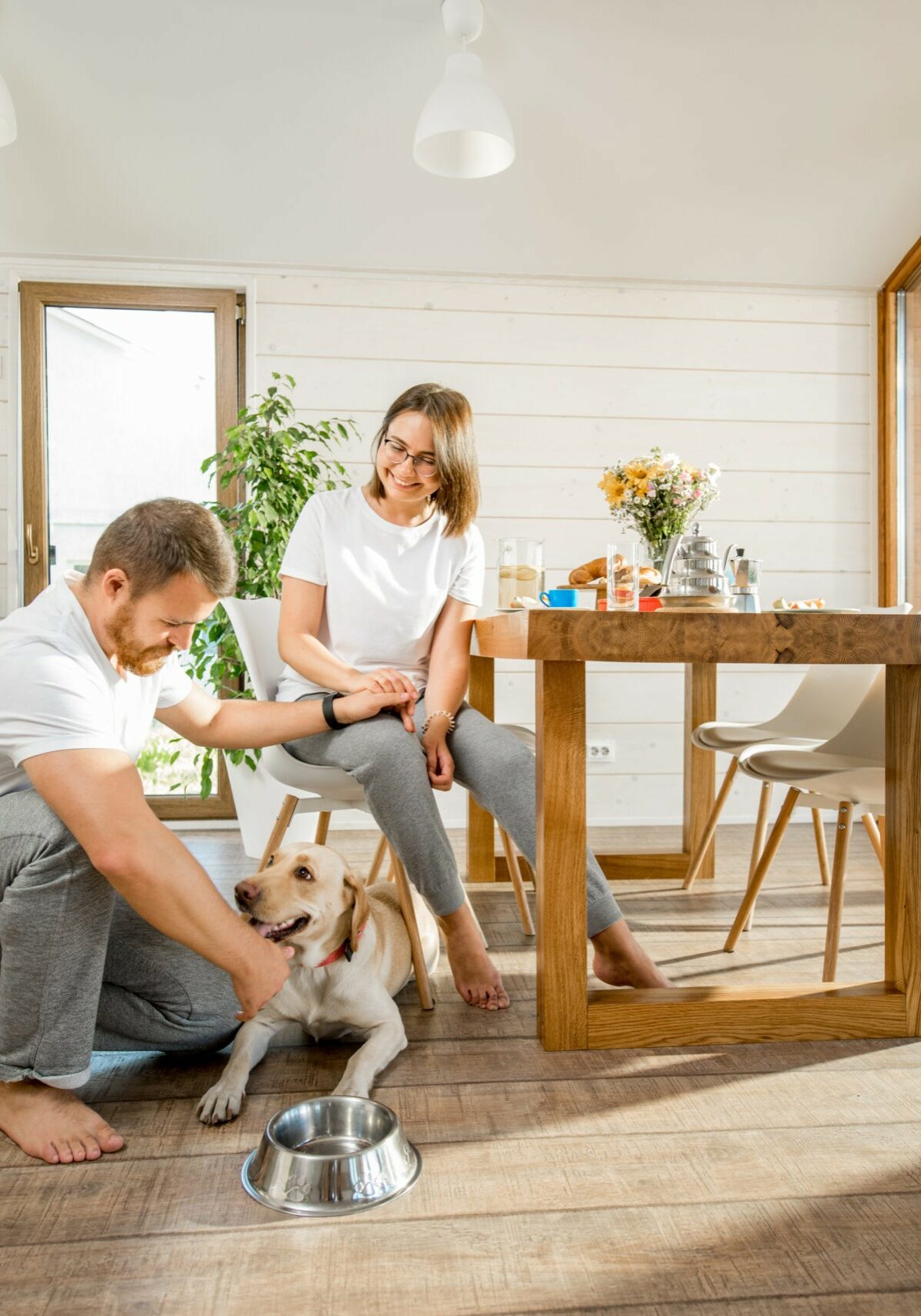 Happy couple with dog at home | White Plains Carpets Floors & Blinds